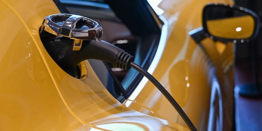 Yellow electric equipment plugged in and charging indoors at a jobsite