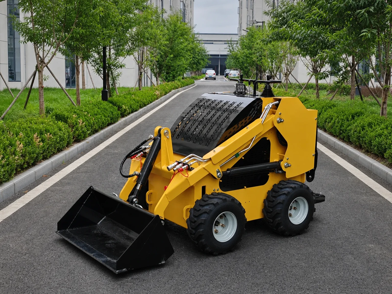 Wheeled mini skid steer loader with compact loading bucket on hard-ground work